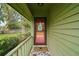 Cozy covered porch with a inviting red front door and cheerful decor, creating a warm welcome at 638 Mount Homer Rd # 3-C, Eustis, FL 32726