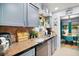 Well-lit kitchen featuring grey cabinets, granite countertops, tile backsplash and stainless steel appliances at 638 Mount Homer Rd # 3-C, Eustis, FL 32726