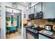 Kitchen featuring modern appliances, granite countertops, and tile backsplash with an adjacent breakfast nook at 638 Mount Homer Rd # 3-C, Eustis, FL 32726