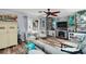 Cozy living room featuring wood floors, a ceiling fan, and a decorative fireplace at 638 Mount Homer Rd # 3-C, Eustis, FL 32726