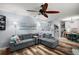 Comfortable living room with L-shaped couch, wood floors, and a view of the adjacent kitchen at 638 Mount Homer Rd # 3-C, Eustis, FL 32726