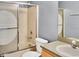 Bathroom with a bathtub, shower with sliding doors, toilet, single sink vanity and framed mirror at 685 Reindeer Dr, Kissimmee, FL 34759