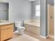 Bright bathroom with vanity, a sink, a toilet, a tub, and a separate shower enclosure at 685 Reindeer Dr, Kissimmee, FL 34759