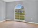Bright bedroom with a large arched window allowing ample natural light at 685 Reindeer Dr, Kissimmee, FL 34759
