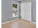 Bedroom featuring neutral tile flooring, a window, light-colored walls, and a double door closet at 685 Reindeer Dr, Kissimmee, FL 34759