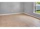 Neutral-toned bedroom with tile flooring and a window for natural light at 685 Reindeer Dr, Kissimmee, FL 34759