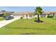 Charming single-story home with well-maintained lawn, garden, and a beautiful palm tree at 685 Reindeer Dr, Kissimmee, FL 34759