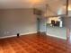 Open-concept living room with terra cotta tile floors, neutral wall paint, and connection to the kitchen at 685 Reindeer Dr, Kissimmee, FL 34759