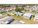 Aerial view of a neighborhood showcasing a single-story home with a well-kept lawn at 705 Prado Dr, The Villages, FL 32159