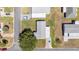Aerial view of a well-maintained single-Gathering home with a brick driveway, surrounded by lush landscaping in a quiet neighborhood at 705 Prado Dr, The Villages, FL 32159