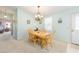 Cozy dining area featuring light wood table set and natural light, perfect for Gathering meals at 705 Prado Dr, The Villages, FL 32159