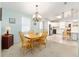Dining room with light wood table and open view to kitchen, perfect for entertaining at 705 Prado Dr, The Villages, FL 32159