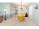 Bright dining room with light walls and chandelier, adjacent to living space at 705 Prado Dr, The Villages, FL 32159