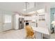Bright kitchen features stainless steel appliances, white cabinetry, ample counter space, and an open layout at 705 Prado Dr, The Villages, FL 32159