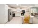 Charming kitchen features white cabinets, black appliances, and functional island with breakfast seating at 705 Prado Dr, The Villages, FL 32159
