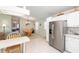 Bright kitchen offers stainless steel refrigerator and blends seamlessly with dining area at 705 Prado Dr, The Villages, FL 32159