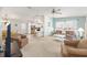Comfortable living area featuring a ceiling fan and open layout connecting kitchen and dining at 705 Prado Dr, The Villages, FL 32159