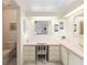 Bright Primary bathroom with a vanity and pink countertops at 705 Prado Dr, The Villages, FL 32159