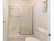Bathroom featuring a glass shower and toilet at 705 Prado Dr, The Villages, FL 32159