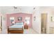Comfortable bedroom featuring a vaulted ceiling and ensuite bathroom at 705 Prado Dr, The Villages, FL 32159