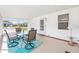 Well lit covered patio featuring a decorative area rug, neutral furniture, and a view of the outdoors at 705 Prado Dr, The Villages, FL 32159