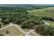 Aerial view of the property showcasing the lush, forested surroundings and serene location at 7938 Jacksons River Rd, Leesburg, FL 34788