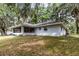Spacious backyard featuring a covered patio area and lush green lawn at 7938 Jacksons River Rd, Leesburg, FL 34788
