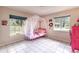 Bright bedroom with a colorful four-poster bed and ample natural light at 7938 Jacksons River Rd, Leesburg, FL 34788