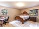 Bedroom with natural light, a decorative wood bed frame, and tile flooring at 7938 Jacksons River Rd, Leesburg, FL 34788