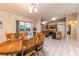 Dining area flows into a kitchen with stainless appliances, a pantry, and lots of natural light at 7938 Jacksons River Rd, Leesburg, FL 34788