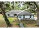 Charming single story home with a welcoming entrance and lush, mature landscaping adding to its curb appeal at 7938 Jacksons River Rd, Leesburg, FL 34788