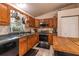 Charming kitchen with wood cabinets, stainless steel appliances, and a window view at 7938 Jacksons River Rd, Leesburg, FL 34788