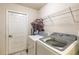 Well-equipped laundry room featuring modern washer and dryer units at 7938 Jacksons River Rd, Leesburg, FL 34788