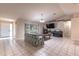 Bright and open living room with neutral walls, large window, and modern tile flooring throughout at 7938 Jacksons River Rd, Leesburg, FL 34788
