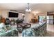 Inviting living and dining area with open layout, featuring tile flooring and lots of natural light at 7938 Jacksons River Rd, Leesburg, FL 34788