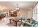 Spacious living area featuring tile floors, adjacent kitchen, and dining room, perfect for entertaining at 7938 Jacksons River Rd, Leesburg, FL 34788