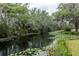 Scenic view of the waterway with lush vegetation, enhancing the home's serene setting at 7938 Jacksons River Rd, Leesburg, FL 34788