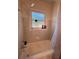 Compact bathroom featuring a tiled shower/tub combination with a rainfall shower head and frosted window at 802 Haselton St, Eustis, FL 32726