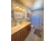 Cozy bathroom showcasing a single sink vanity with modern fixtures, framed mirror and shower with patterned curtain at 802 Haselton St, Eustis, FL 32726