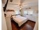 Bright bedroom features hardwood floors, two large windows, and decorative 'Mr. & Mrs.' wall decor at 802 Haselton St, Eustis, FL 32726