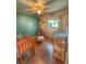 Charming Bedroom featuring a crib, changing table, and cozy chair with wood laminate floors and lots of natural light at 802 Haselton St, Eustis, FL 32726