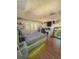 Bright bedroom features wood flooring and is equipped with a modern entertainment setup at 802 Haselton St, Eustis, FL 32726
