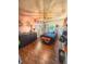 Stylish bedroom with dark furniture, wood laminate flooring, and unique decor; filled with natural light at 802 Haselton St, Eustis, FL 32726