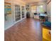 Spacious bonus room boasts wood floors, French doors, a workstation, and a cheerful calendar at 802 Haselton St, Eustis, FL 32726