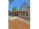 Low angle view of single story home with stone accents, patio, and manicured lawn at 802 Haselton St, Eustis, FL 32726