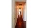 Long hallway showcasing wood flooring and easy access to other rooms in the house at 802 Haselton St, Eustis, FL 32726