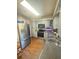 Updated kitchen features stainless steel appliances, light gray cabinetry, and hardwood floors at 802 Haselton St, Eustis, FL 32726