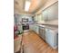 Modern kitchen with updated appliances, neutral cabinets, and laminate hardwood flooring at 802 Haselton St, Eustis, FL 32726