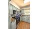 Modern kitchen featuring sleek stainless steel appliances, neutral cabinetry, and hardwood floors at 802 Haselton St, Eustis, FL 32726