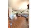Open-concept living room with hardwood floors connecting to dining and Gathering areas at 802 Haselton St, Eustis, FL 32726